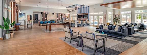 A spacious living room with wooden floors and furniture.