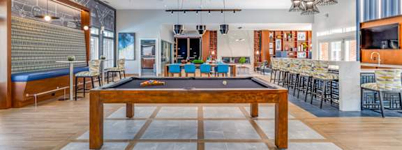 A room with a pool table and a ping pong table.