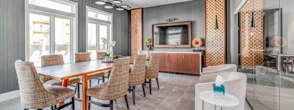 A modern dining room with a wooden table and chairs.
