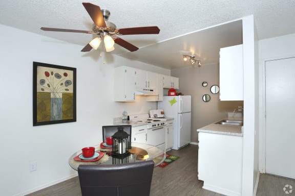 Dining room set with kitchen in the background