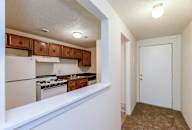 a kitchen with white appliances and wooden cabinets at Waldo Heights, Kansas City, 64131