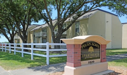 a picture of the pecan acres apartments sign