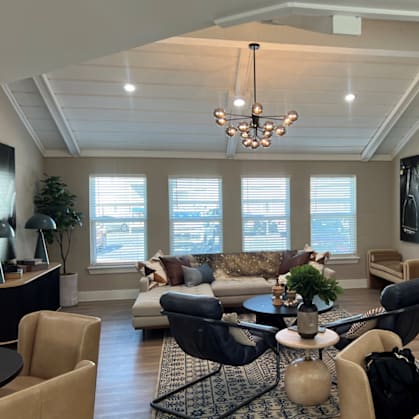 A living room with a fireplace and a television mounted on the wall.