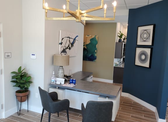 A room with a desk and chairs.