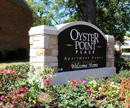 a sign for oyster point place in front of a building