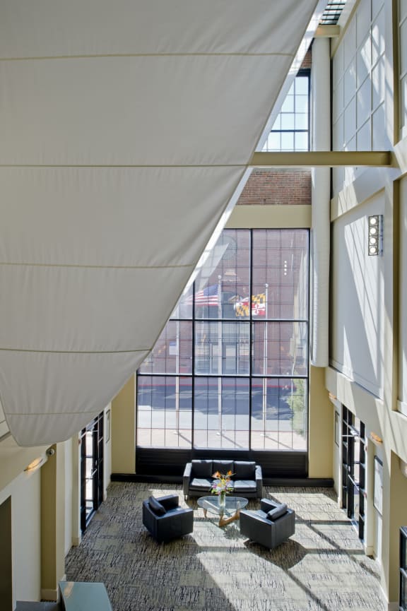 the lobby of a building with large windows and couches at Tindeco Wharf, Baltimore, 21224