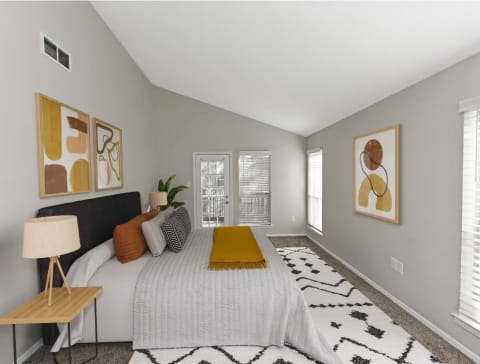a bedroom with a large bed and some pictures on the wall