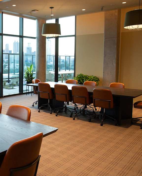 A conference room with a long table and chairs. at Scout Living, powered by Placemakr Apartments, Atlanta, GA, 30308