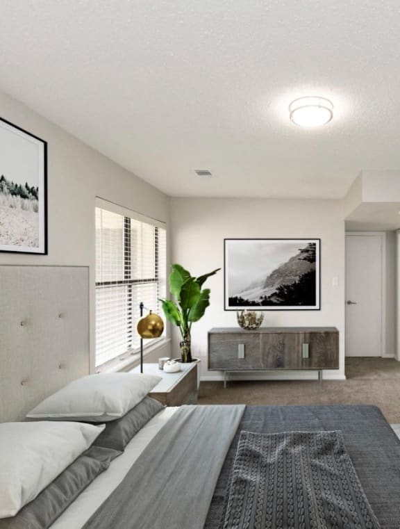 a bedroom with a bed and a dresser and a bathroom