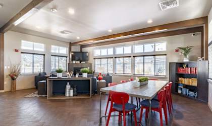 A modern living room with a dining table and chairs.