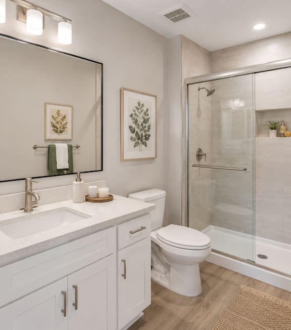 A bathroom with a white toilet, sink, and a mirror.