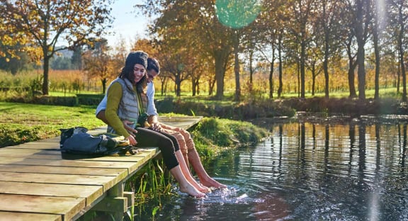 Couple Sitting By Water