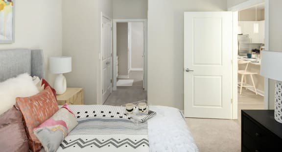 a bedroom with a bed and a door to a bathroom