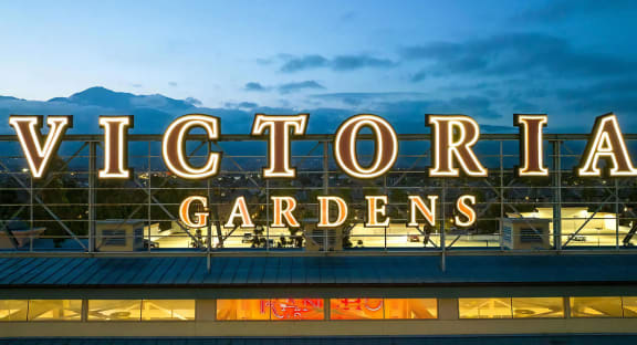 Victoria Gardens Sign Lit in Evening