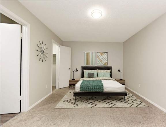 a bedroom with a bed and a door to a closet