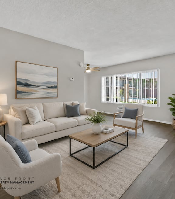 A well-lit, modern kitchen and living room with a dining area.