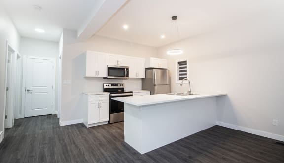 a kitchen with white cabinets and a white counter top