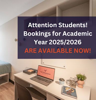 A room with a bed, desk, and a laptop on it with a sign about bookings for academic year 2025/2026.