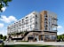 A modern multi-story building with balconies and large windows.