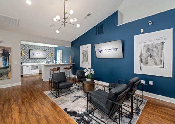 a living room with blue walls and a table and chairs