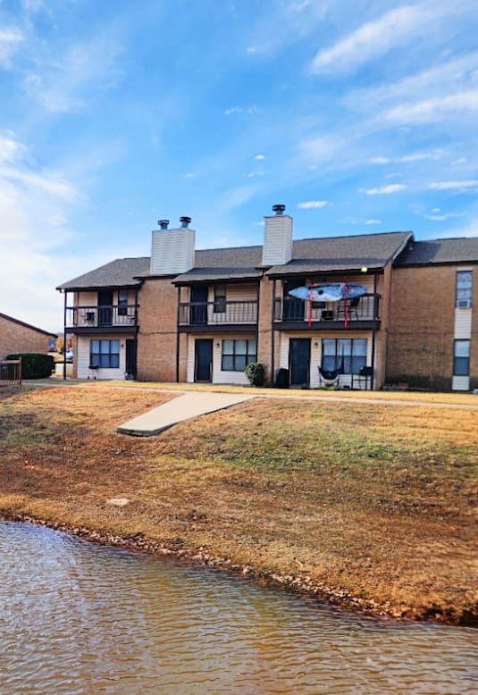 A row of houses with a body of water in front.