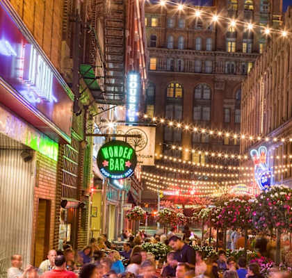 a city street filled with people at night