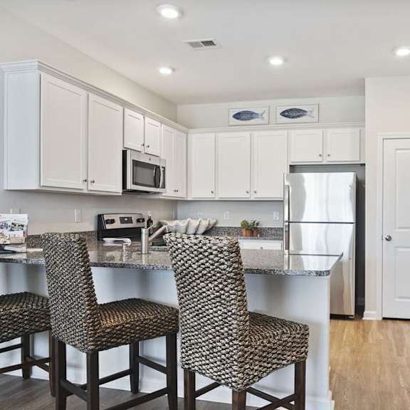 A kitchen with a table and chairs. at Stepping Stone at Bridgewater Apartments, Little River