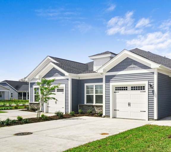 A two-story house with a garage and a driveway. at Stepping Stone at Bridgewater Apartments, Little River