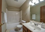 Thumbnail 31 of 31 - A bathroom with a toilet, sink, and bathtub.