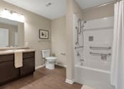 Thumbnail 45 of 45 - A bathroom with a toilet, sink, and bathtub.