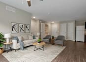 Thumbnail 42 of 45 - A living room with a white couch, grey armchairs, and a coffee table.