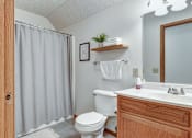 Thumbnail 27 of 29 - A bathroom with a toilet, sink, and shower.