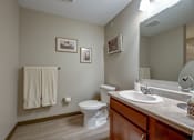 Thumbnail 43 of 43 - A bathroom with a toilet, sink, mirror, and towel rack.