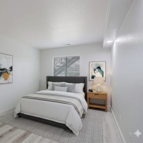 A bedroom with a large bed and a painting on the wall.