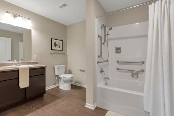 A bathroom with a toilet, sink, and bathtub.