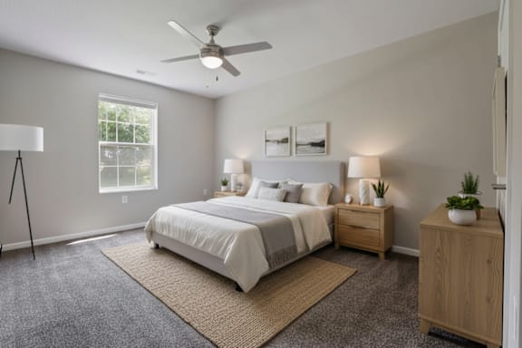 A bedroom with a bed, nightstand, and a ceiling fan.