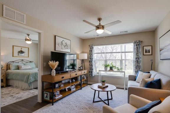 A living room with a television, a couch, and a coffee table.