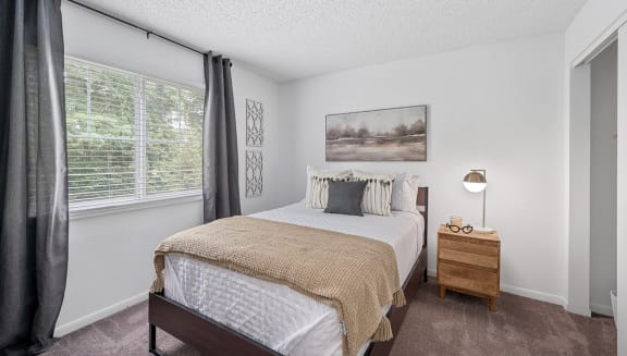 a bedroom with a bed and a window