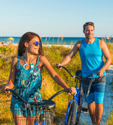 Couple with bike on a pathway Carolina Club in Daytona Beach Florida