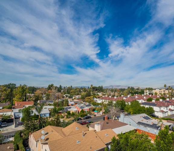A view of a residential area with houses and trees.