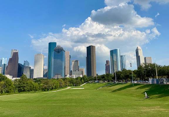 a park with the city skyline in the background