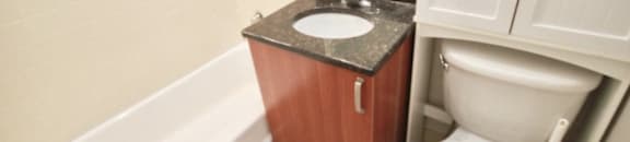 Bathroom with full tub and extra storage above the toilet