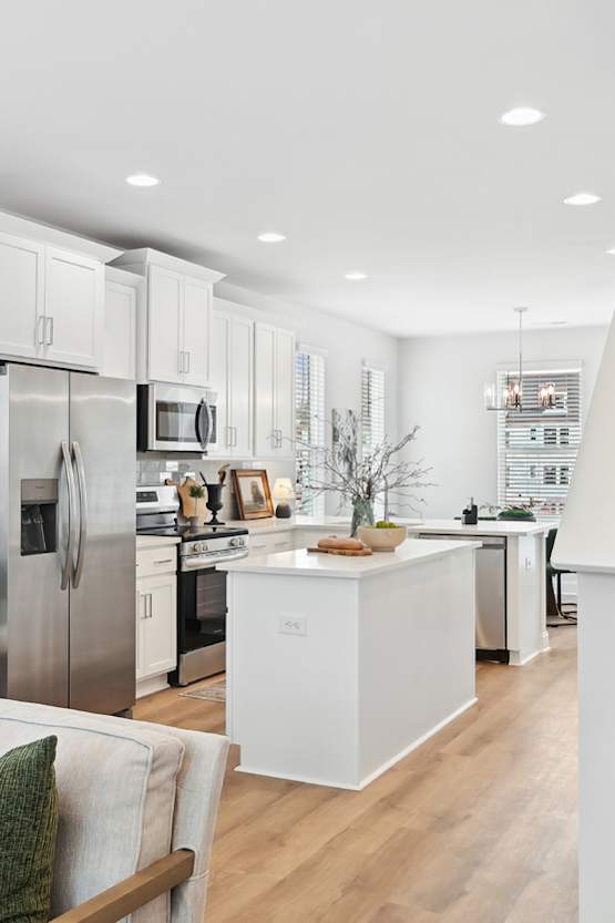 A modern kitchen with a staircase leading to the upper floor.
