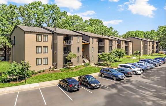 A parking lot in front of apartment buildings.
