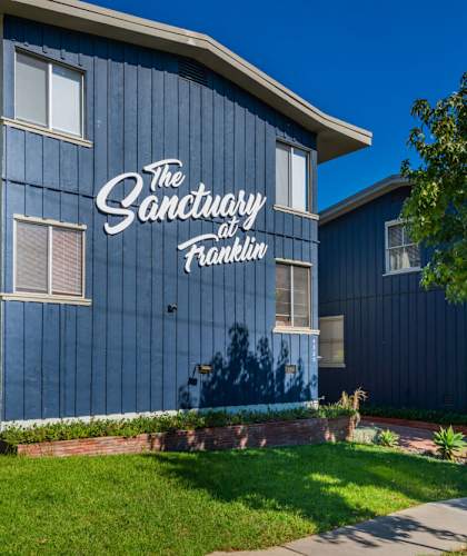 a blue building with a sign that reads the sanctuary of radiance