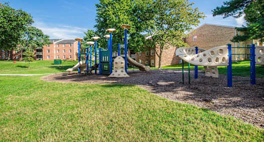 A playground with a slide and a swing set.