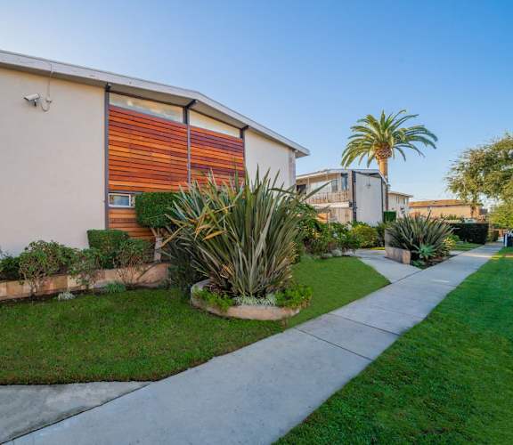 A modern house with a red and orange garage door.
