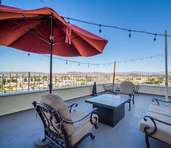 A patio with two chairs and a table with a view of the city.