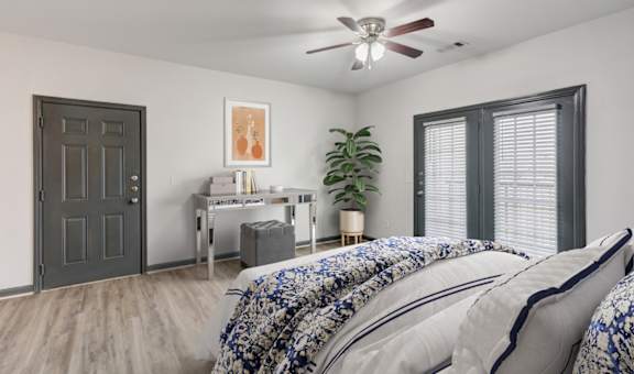 Parc at Metro Center Apartments in Nashville, TN photo of a bedroom with a large bed and a ceiling fan