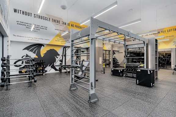 A gym with a sign that says "Without Struggle There Can Be No Progress".